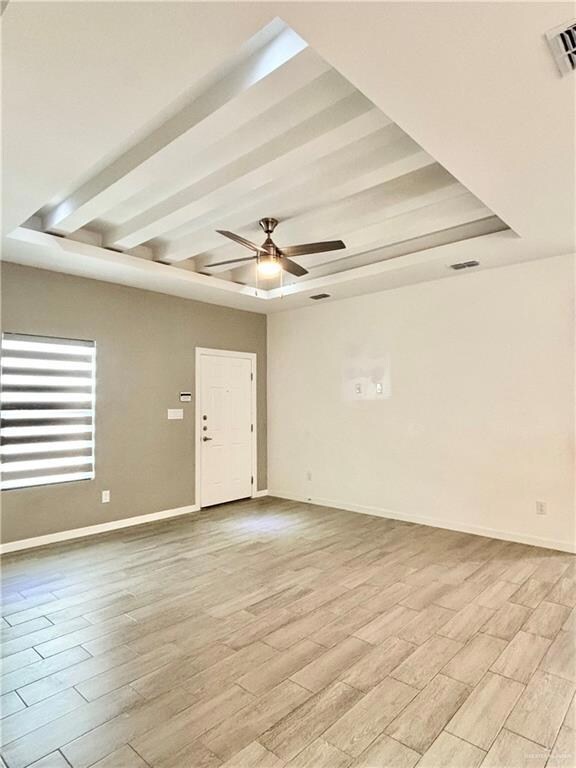 Living room with decorative ceilings and fan.