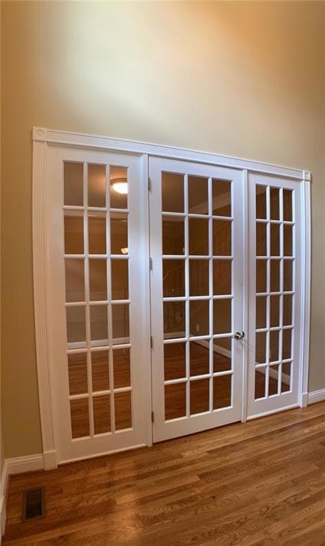 Detailed view of wood finished floors and french doors