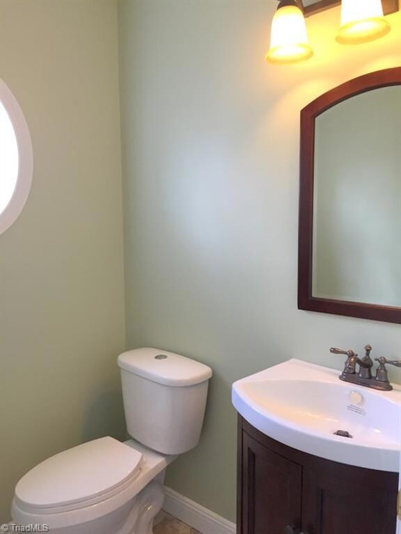 Remodeled 1/2 bath with new toilet, vanity, mirror and fixtures!