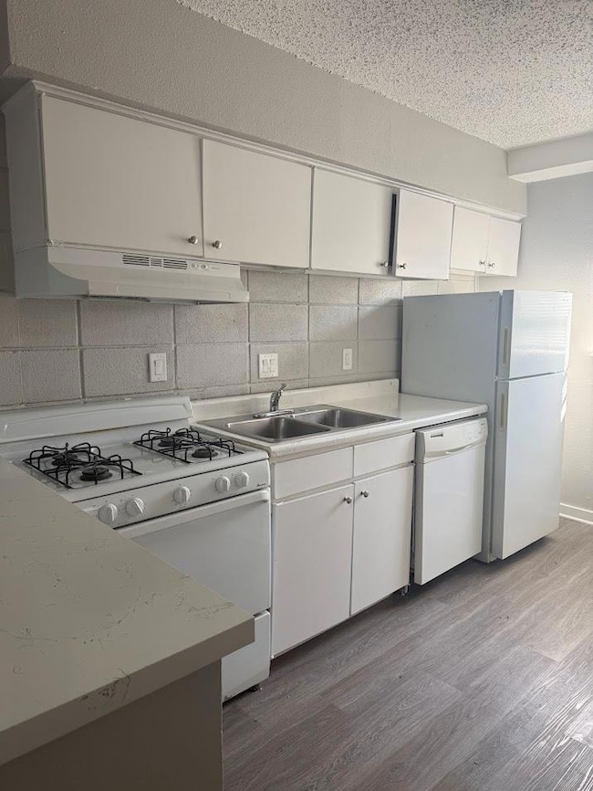 Kitchen featuring white appliances, under cabinet