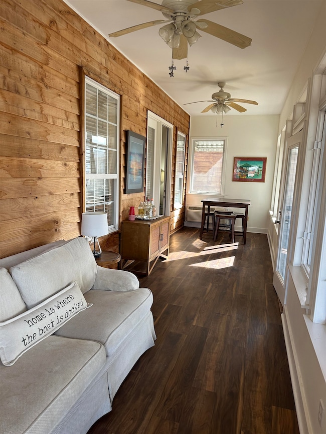 Sunroom / solarium featuring ceiling fan