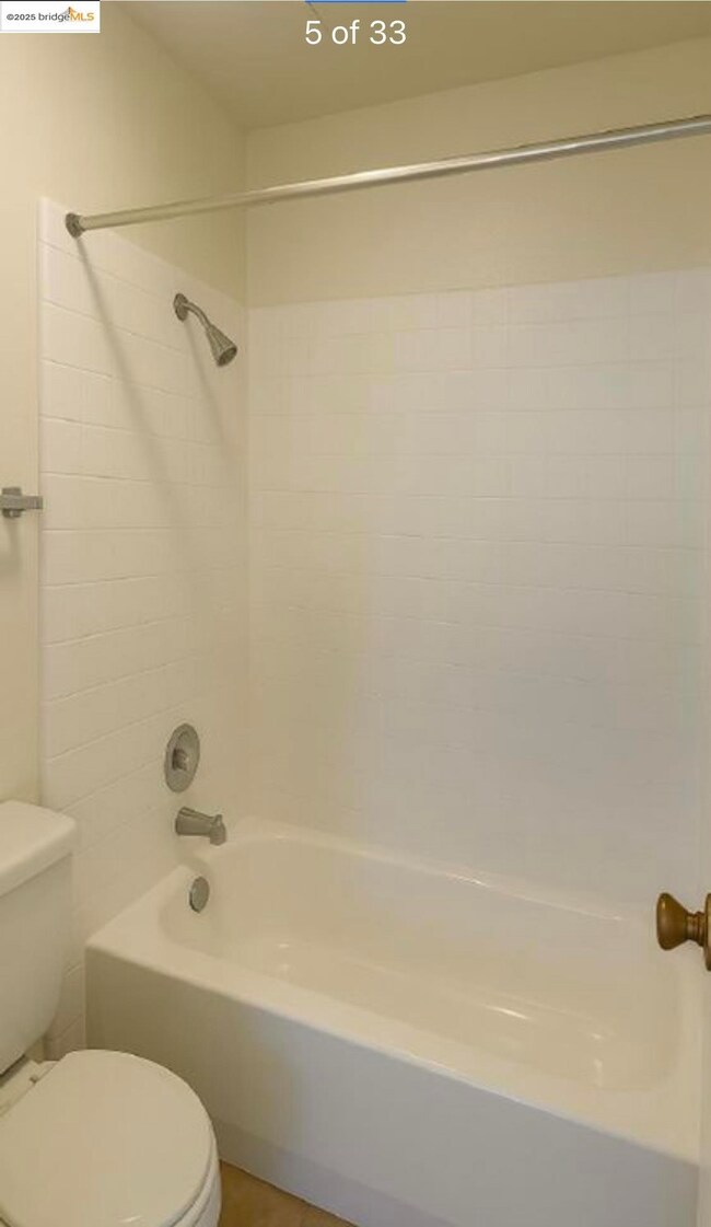 Bathroom featuring  shower combination and tile patterned flooring