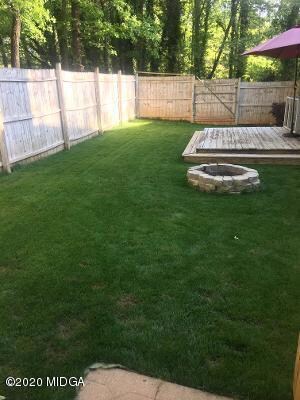 deck and fenced backyard area