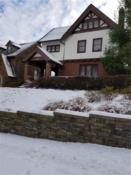 Distinctive Tudor Is Situated On A Landscaped Corn