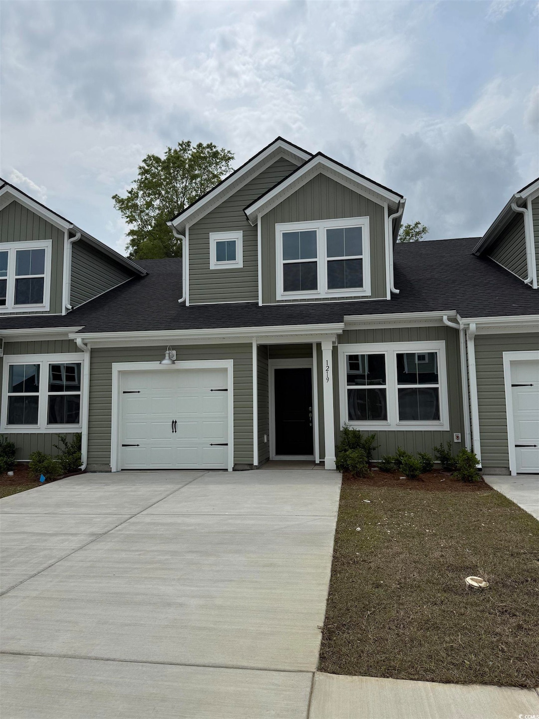 View of front of property with concrete driveway a