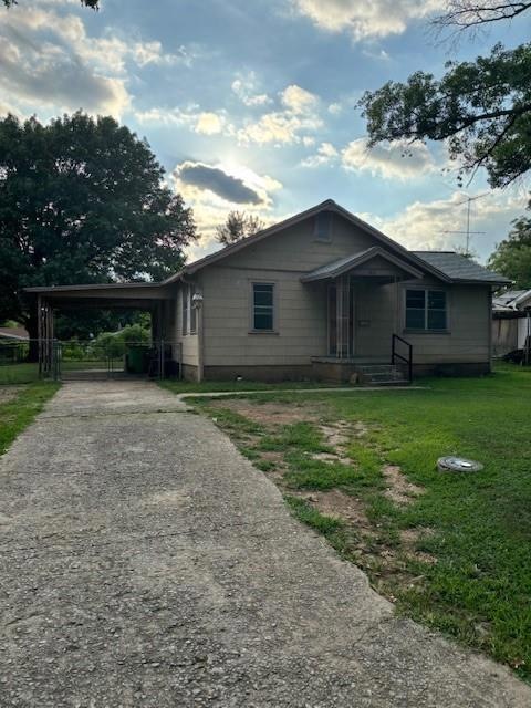 View of front of property featuring a carport, cov