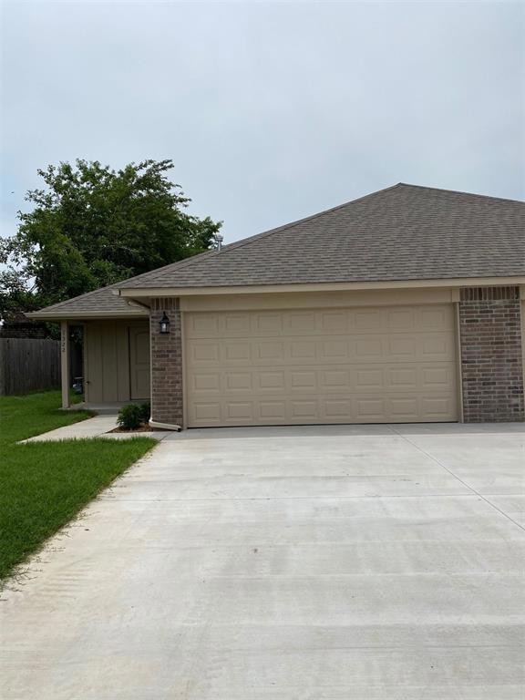 View of front facade with driveway, brick siding, 