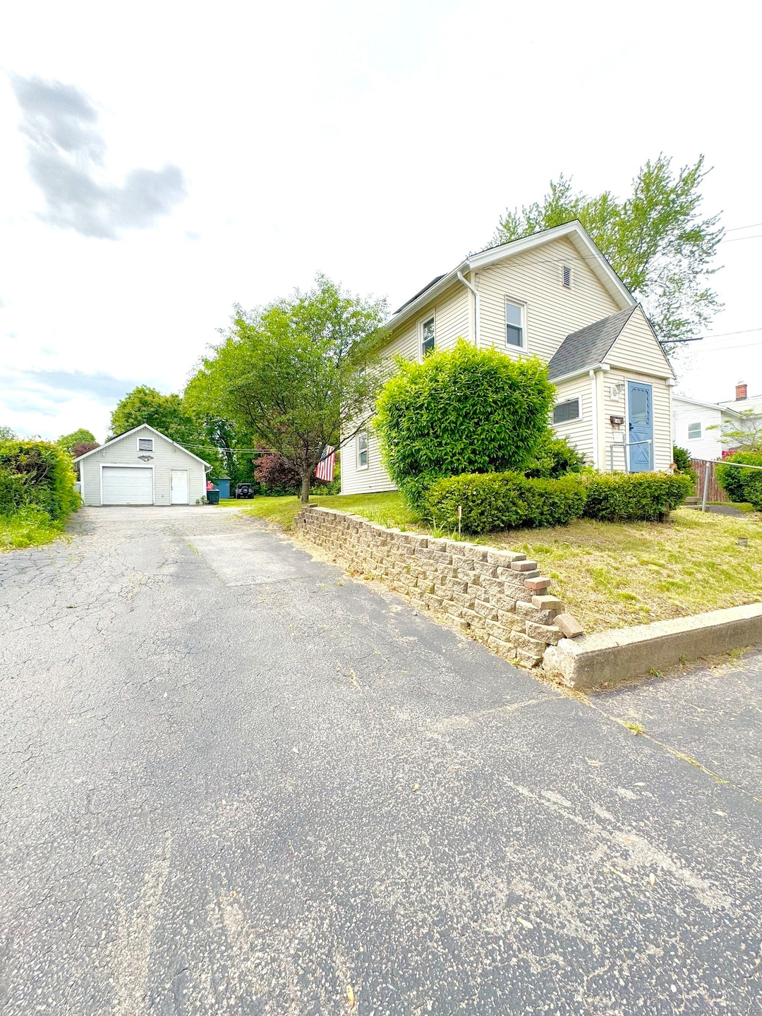 Front of house, paved driveway and 1 car garage