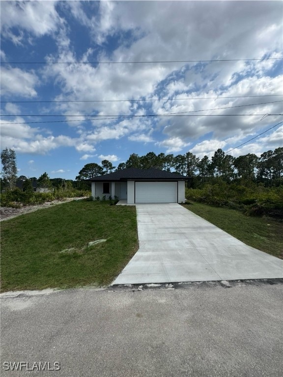 View of front facade featuring concrete driveway,