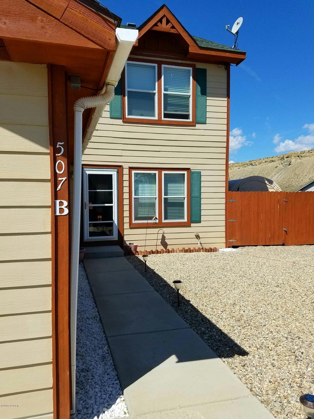 Front with view of fenced side yard