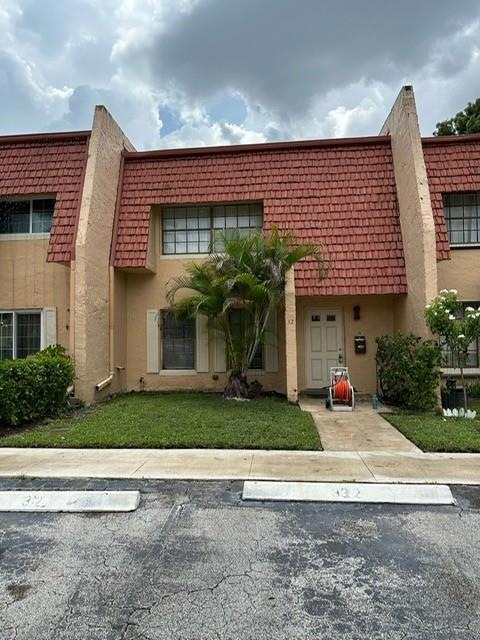 #32 front view with 2 assigned parking spots at your door marked 