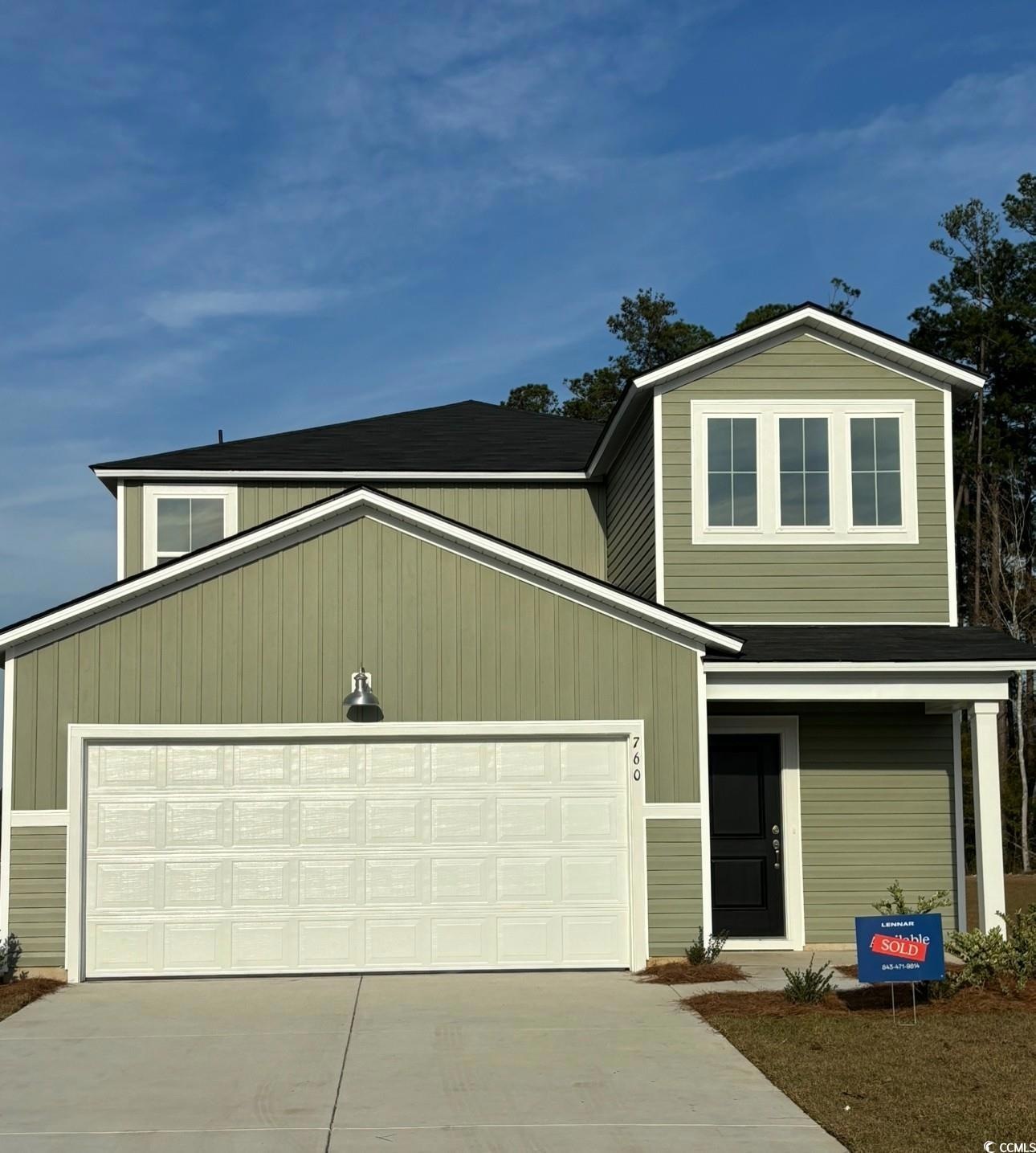 View of front of property featuring a garage