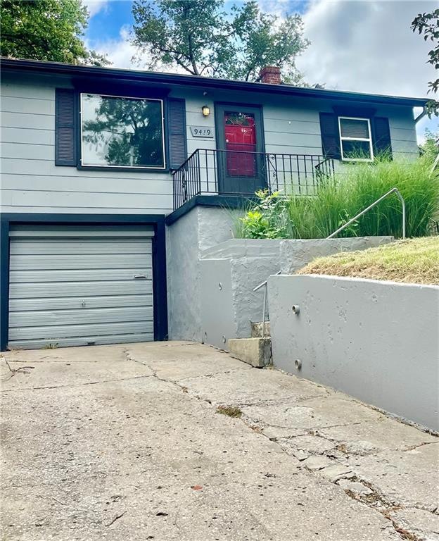 View of front of home with a garage and front lawn