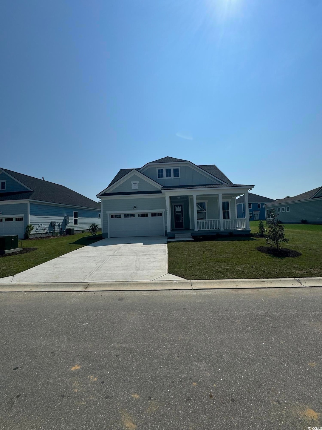 Ranch-style house featuring a garage, central AC unit, a front yard, and covered porch