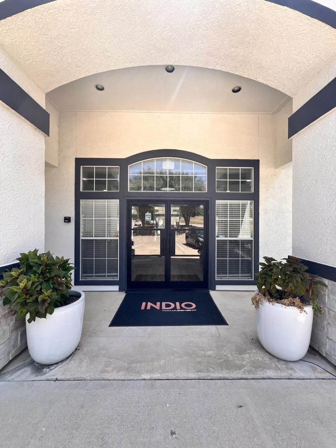 View of exterior entry featuring stucco siding, french doors, and a patio