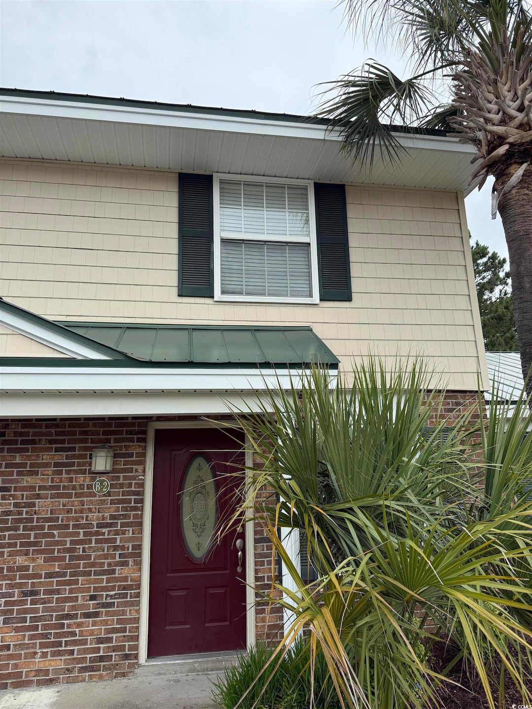 Property entrance with brick siding
