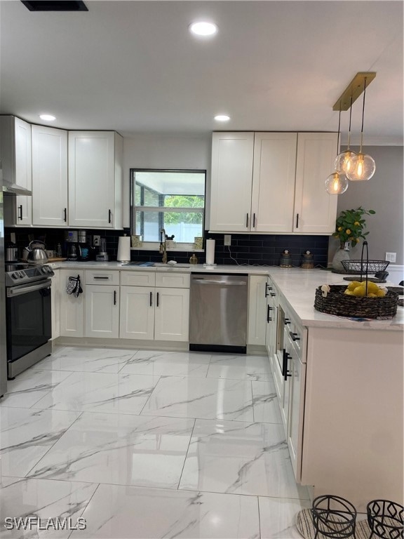 Kitchen with dishwasher, range, tasteful backsplas