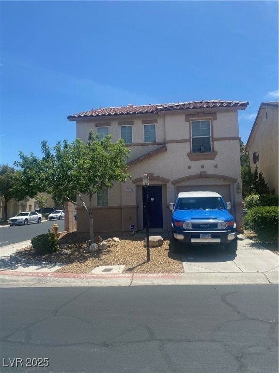 View of front of house featuring driveway, a tiled