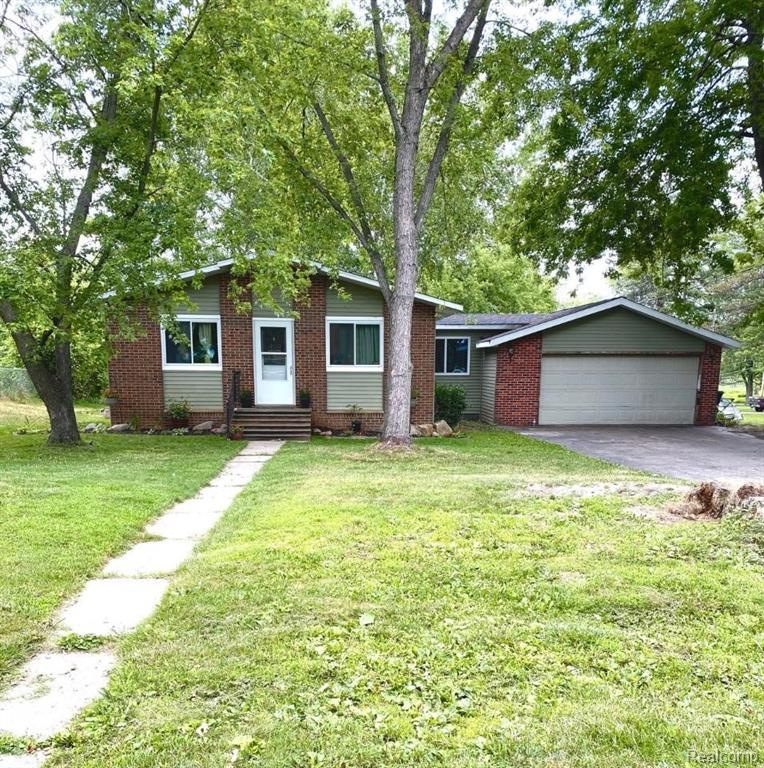 Large peaceful corner site. Front photo showing New Vinyl windows, New roof and New vinyl siding. Large attached two car garage.