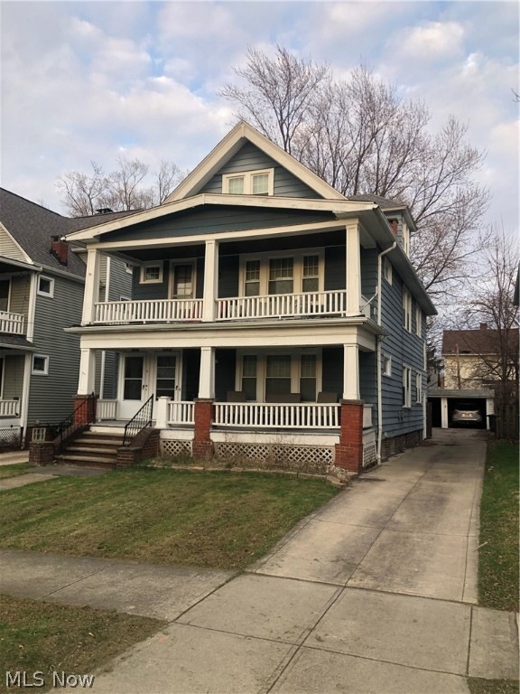 View of front of house with a garage and a porch