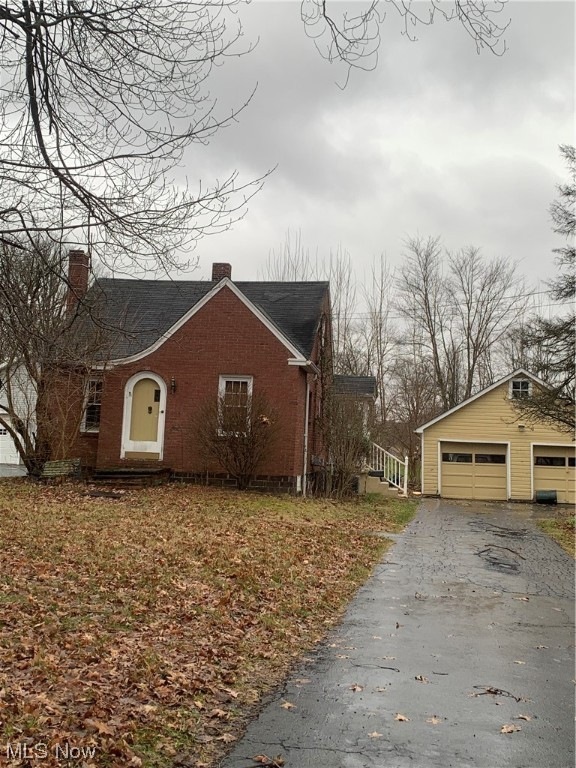 View of front of property with a garage and driveway.