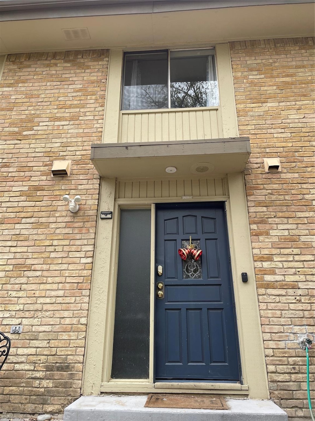 Doorway to property with brick siding