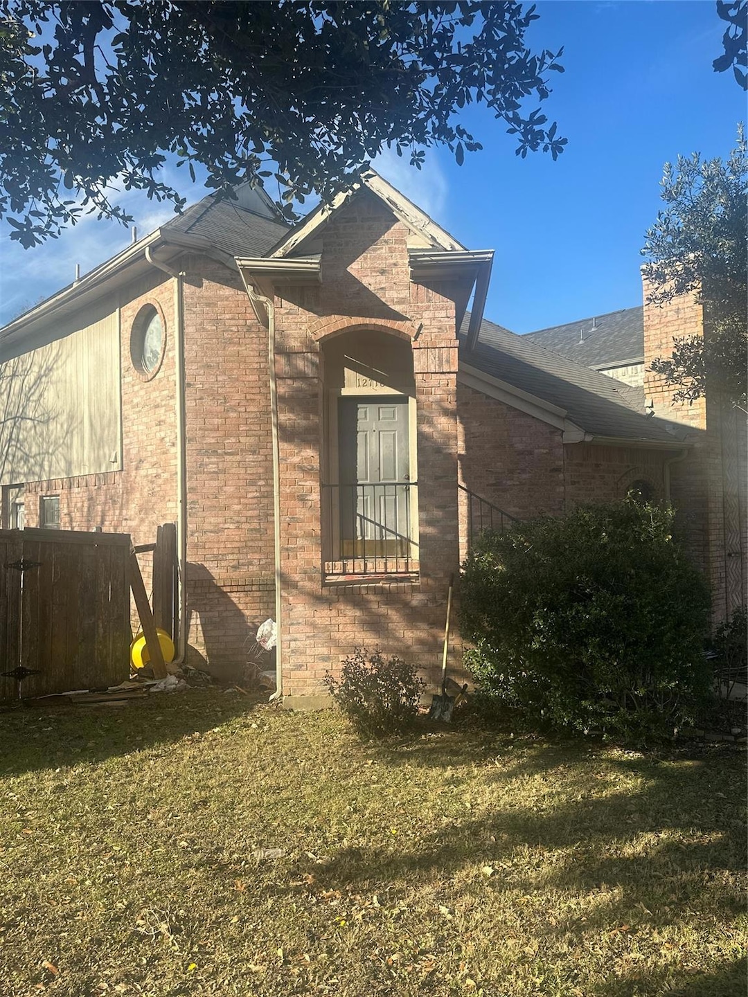 View of side of home featuring a lawn