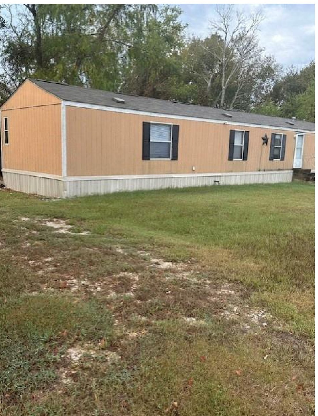 View of home's exterior with a yard