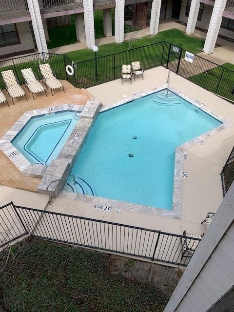 View of swimming pool with a community hot tub, a 
