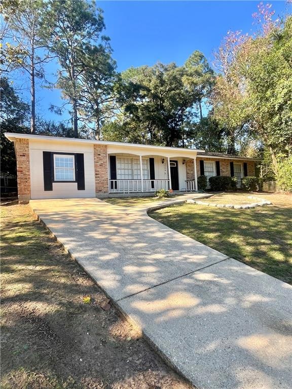 Ranch-style home featuring covered porch and a fro