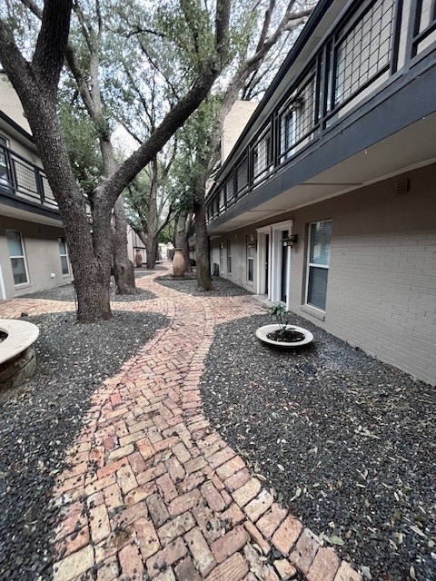 View of yard featuring a balcony and an outdoor fire pit