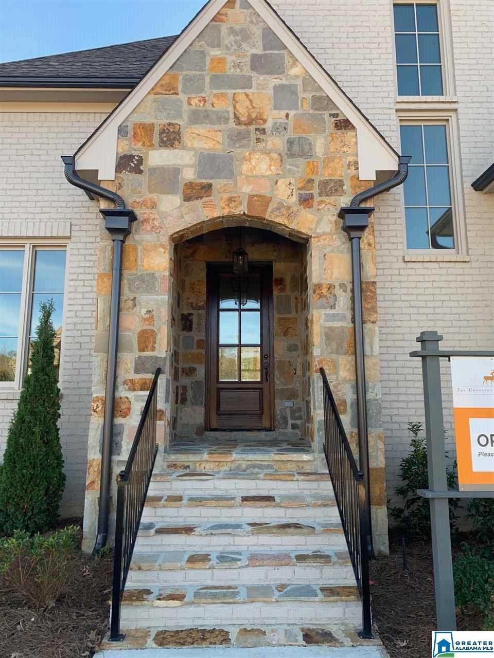 Beautiful entryway featuring rock accents, gas lantern (to come), and an 8 foot tall mahogany door.  What a first impression!
