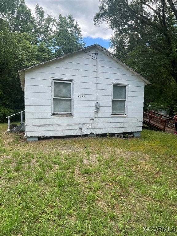 Back of house featuring a lawn