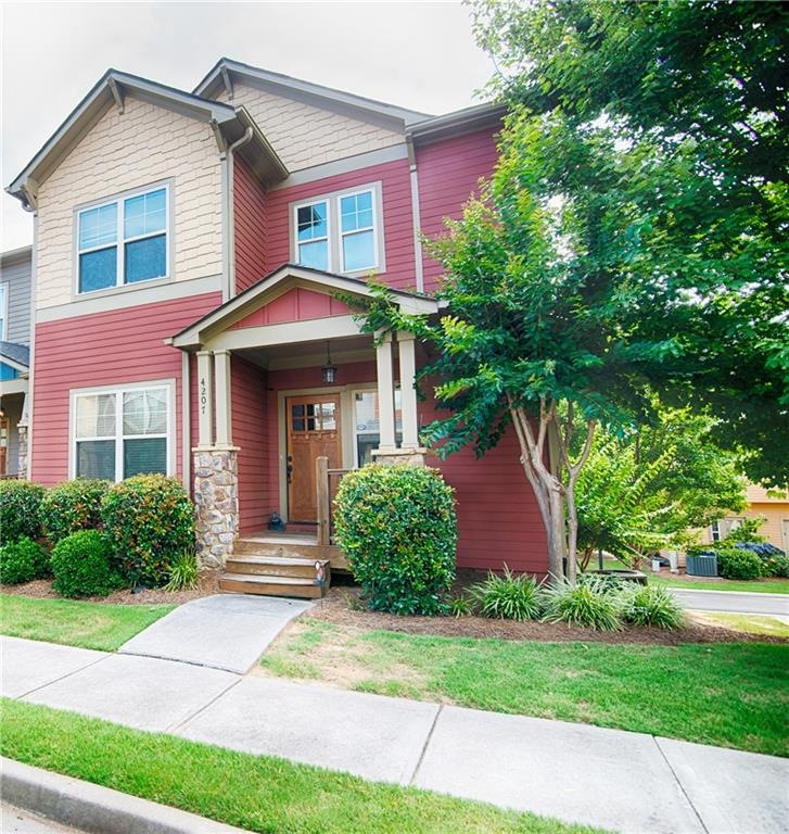 Adorable covered front porch and designer door mak