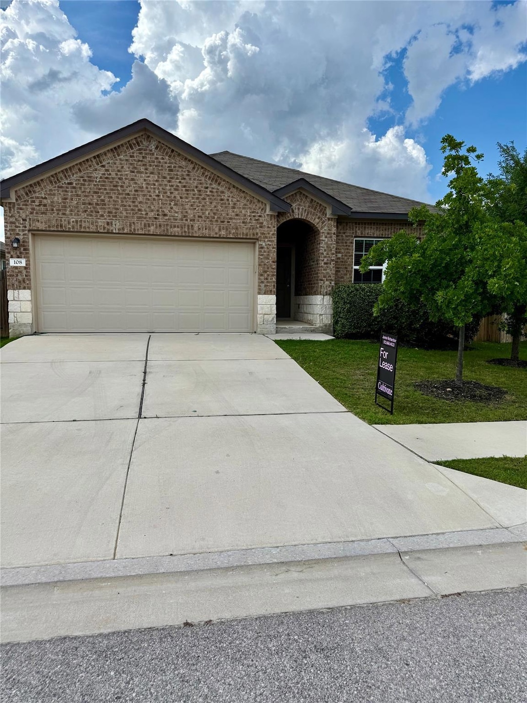 Ranch-style house featuring brick siding, a garag