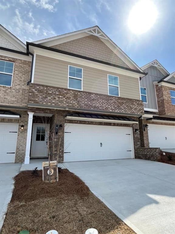 Multi unit property with brick siding, driveway, a