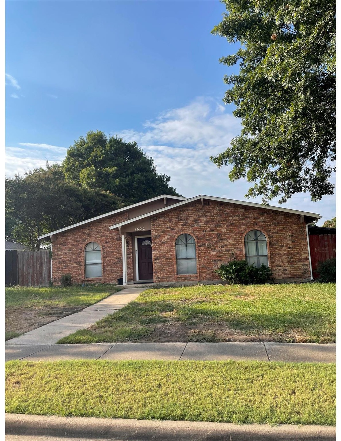 Single story home featuring a front lawn