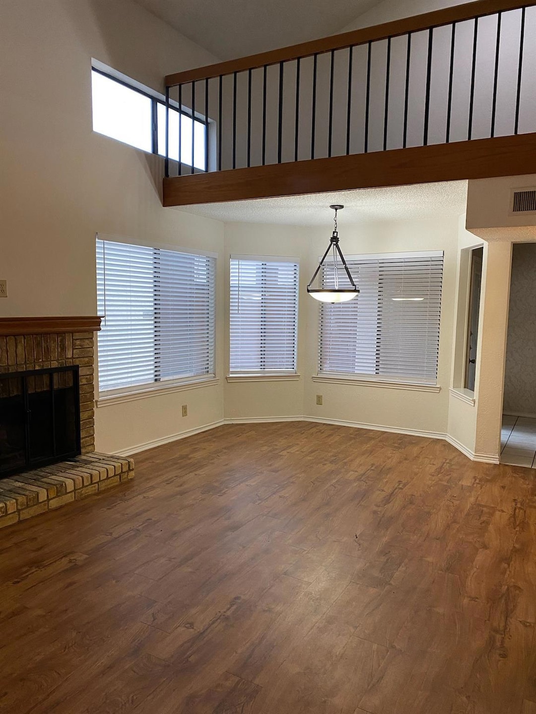 Unfurnished living room with dark wood-style floor