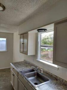 Kitchen with a textured ceiling and sink