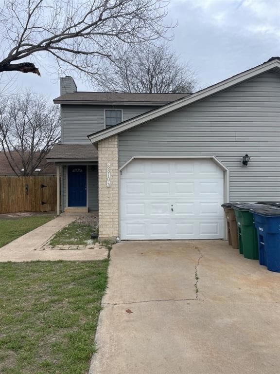 View of front facade with concrete driveway, a ch