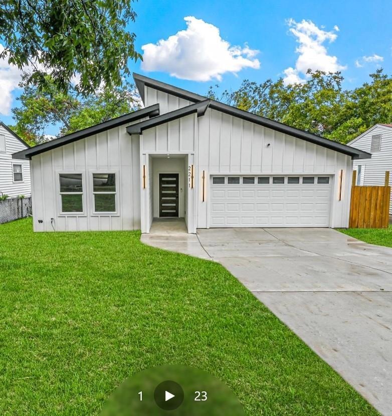 Modern inspired farmhouse with a front lawn and a 