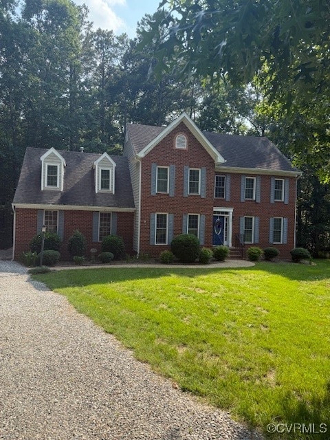 View of front of property with brick siding and a
