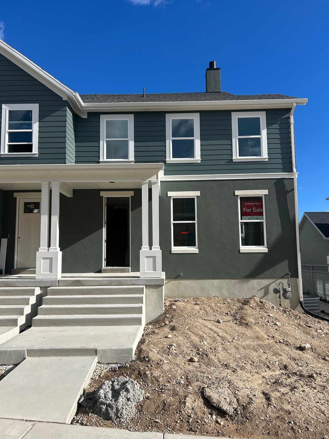 View of front facade with a porch and a chimney