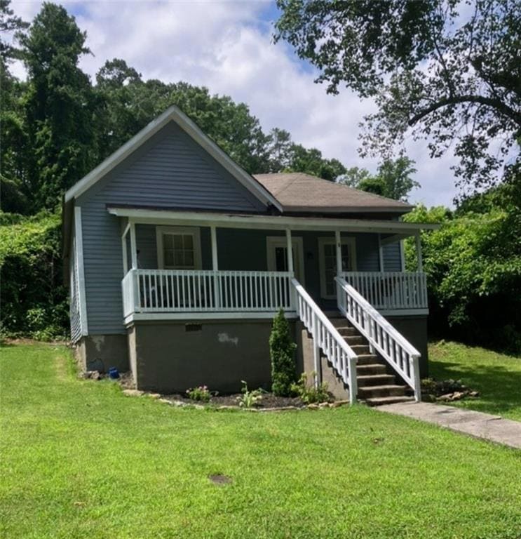 Bungalow with a front yard, a porch, and stairs