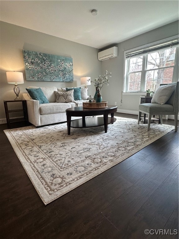 Living room with a wall unit AC, baseboards, and w