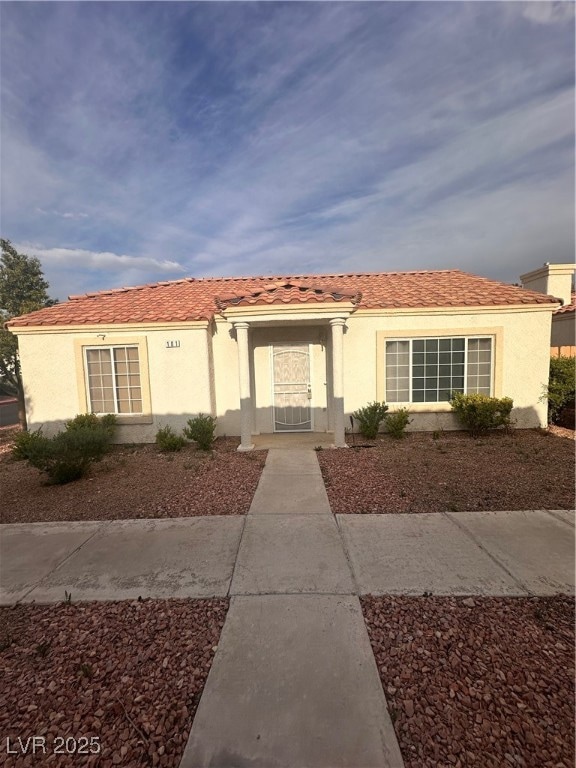 View of front of house featuring stucco siding and