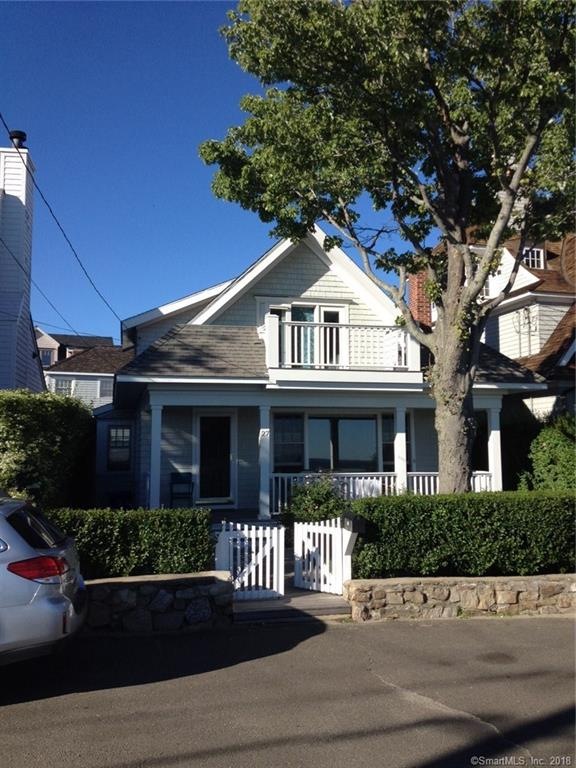 Front of home with upper and lower open porches lo