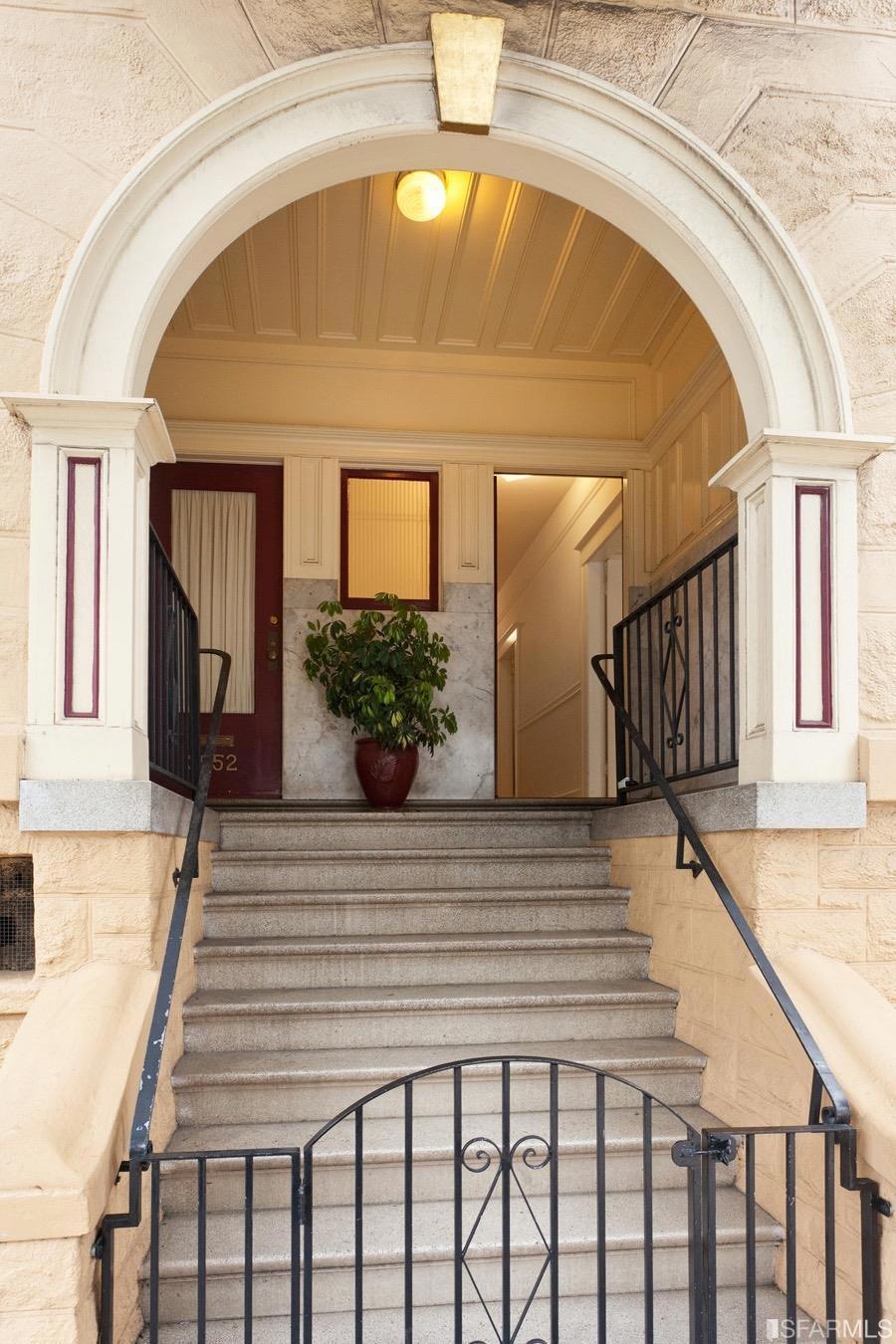 Terrazzo stairs lead to a landing clad in original