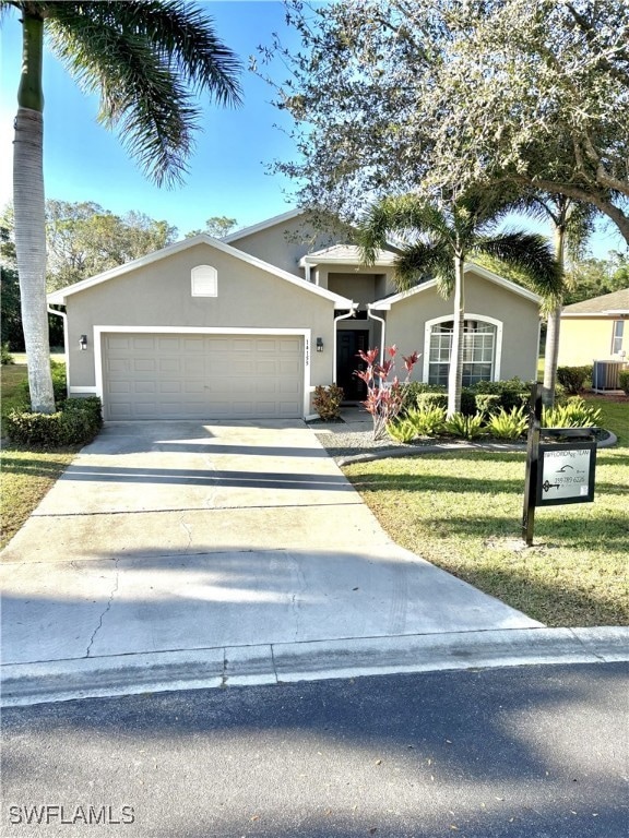 View of front of home featuring a front yard, a ga
