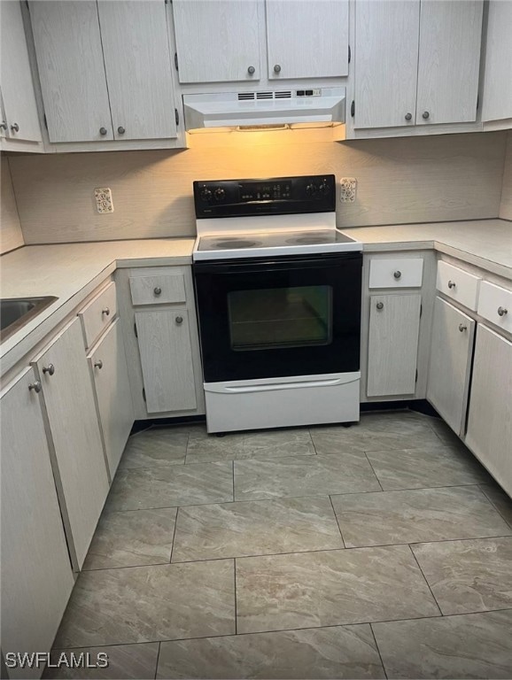 Kitchen with electric stove, under cabinet range h